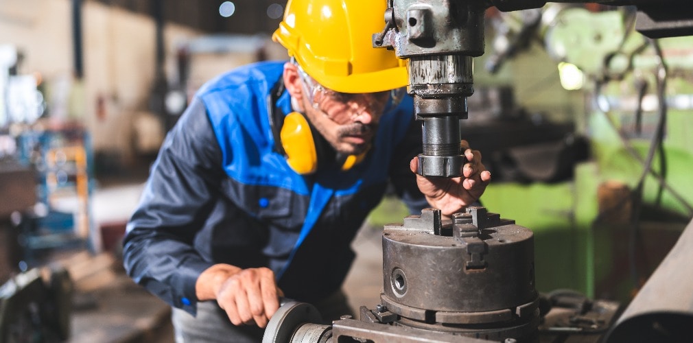 Production engineers are assisting adjusting and maintaining factory machine, Male workers technician examining control the industrial technology tool, professional repair men work in industry plant